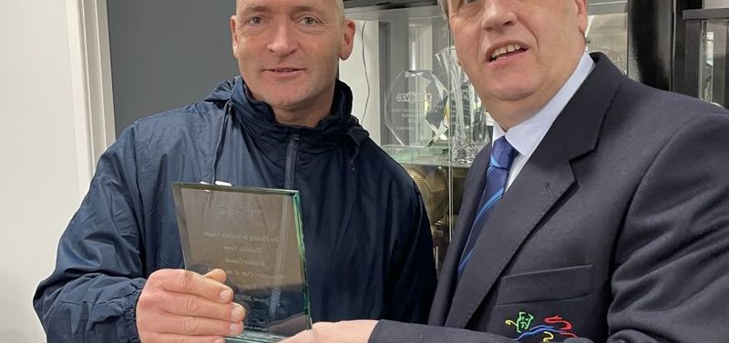 Coalville manager Adam Stevens receives the award from Southern League Director Dave Stephens