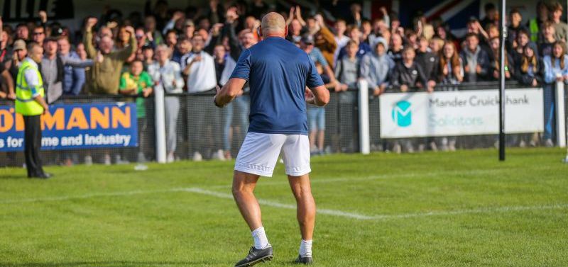 Coalville boss Adam Stevens celebrates in front of his supporters